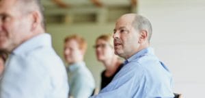 Picture of people in a meeting at the Moller Centre