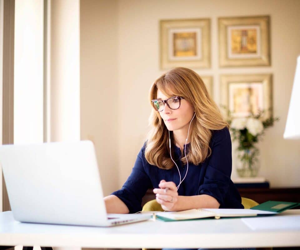 Picture of women with glasses on laptop