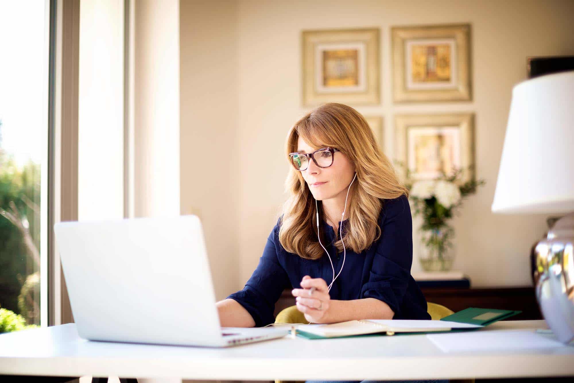 Picture of women with glasses on laptop