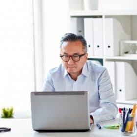 Picture of a man working at a laptop