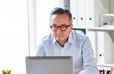 Picture of a man working at a laptop